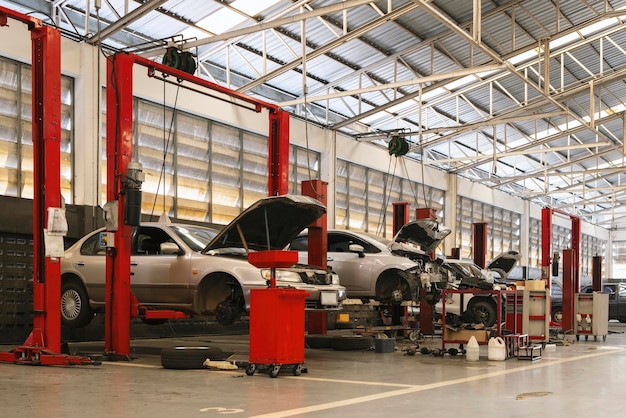 Car repair in garage service station with softfocus and over light in the background