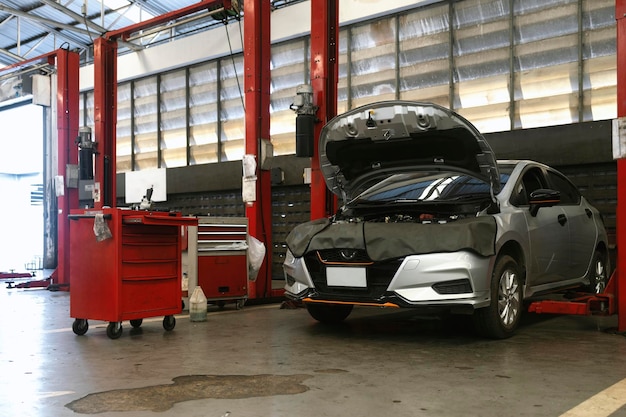 Car repair in garage service station with softfocus and over light in the background