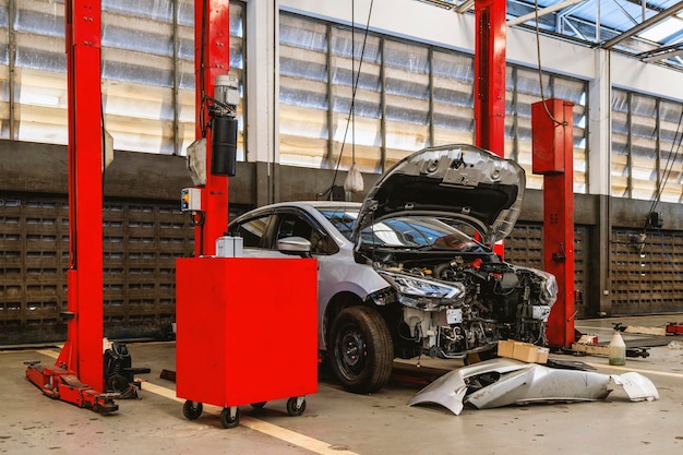 car repair in garage service station with softfocus and over light in the background