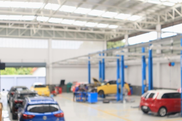 Car service centre with auto at repair station bokeh light defocused blur background