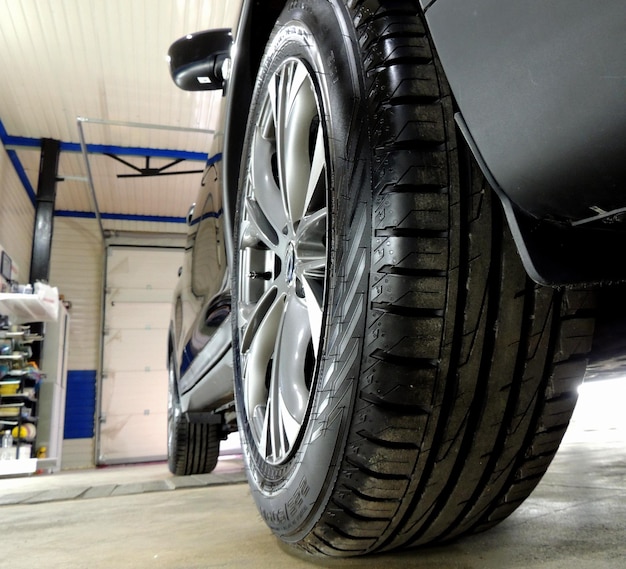 Car In Service Station Of Cleaning Wheels 
