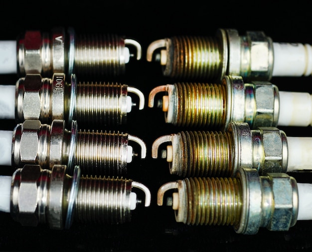 car spark plug isolated on black background closeup