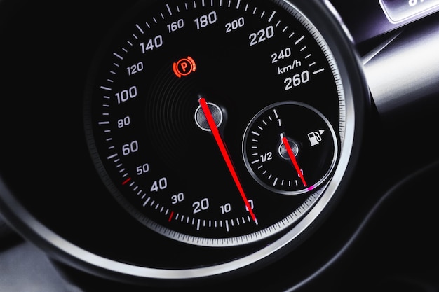 Car speedometer luxury dashboard with glowing red indicators closeup view background photo