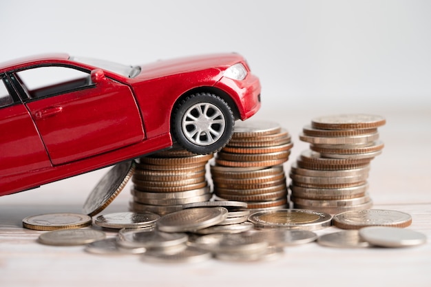 Photo car on stack of coins. car loan, finance, saving money, insurance and leasing time concepts.