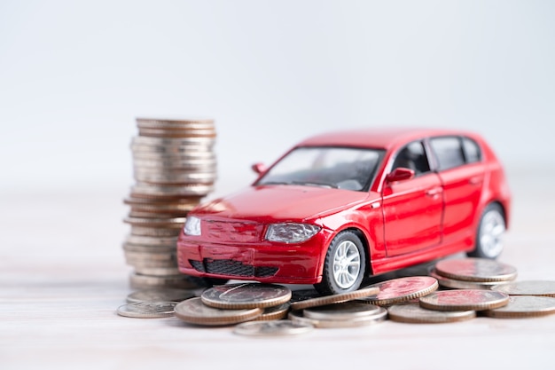 Car on stack of coins. Car loan, Finance, saving money, insurance and leasing time concepts.