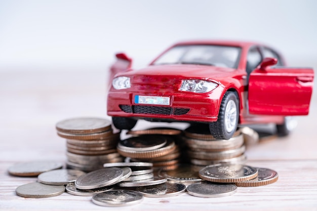 Car on stack of coins. Car loan, Finance, saving money, insurance and leasing time concepts.