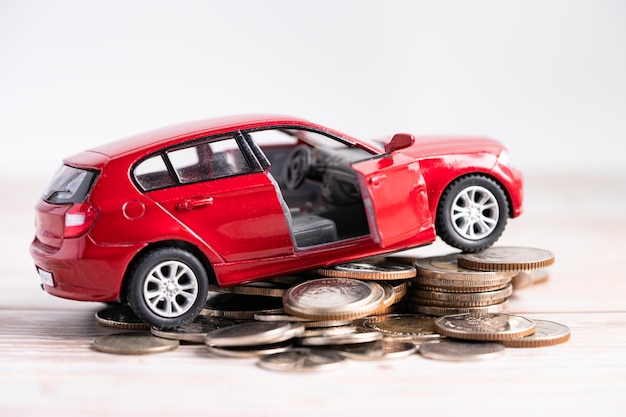 Car on stack of coins Car loan Finance saving money insurance and leasing time concepts