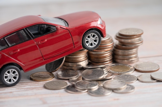 Car on stack of coins Car loan Finance saving money insurance and leasing time concepts