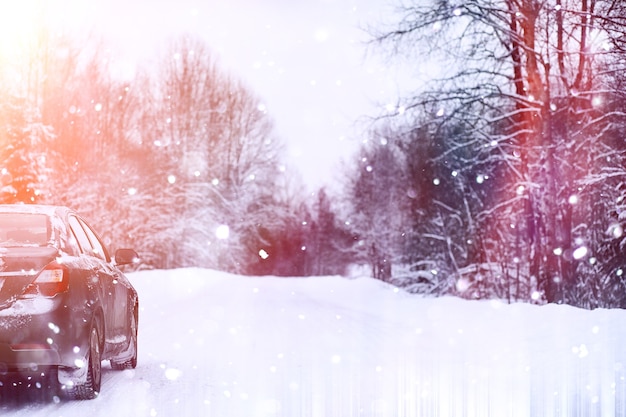 The car stands on a snow-covered road in a wintertime cloudy day