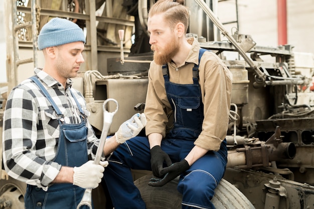 Car Technicians Discussing Work