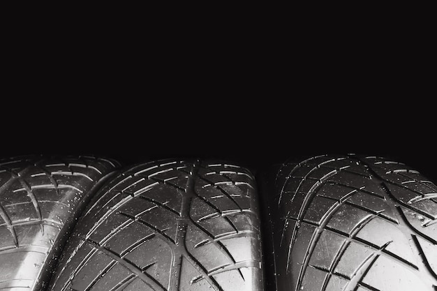 Photo car tire row isolated on black background with copy space for text old car tire with scratch car tire concept