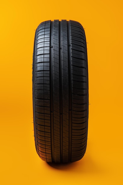 Car tires isolated on yellow background close up