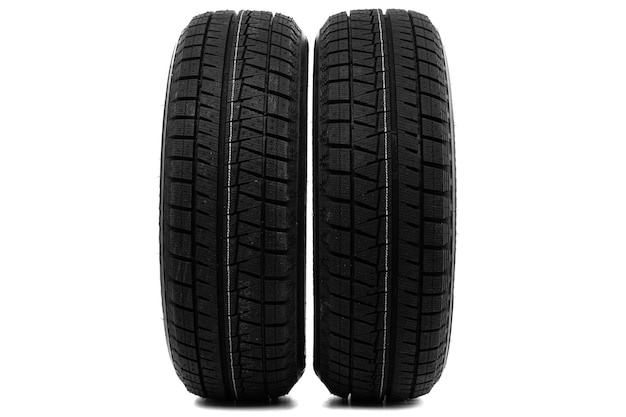 Car tires with winter tread on white background