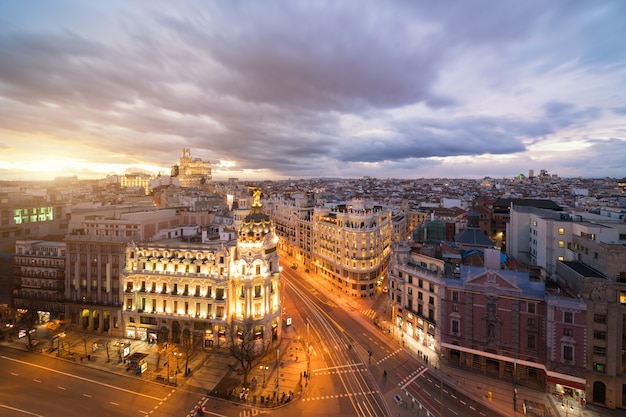 Car and traffic lights on Gran via street, main shopping street in Madrid at night