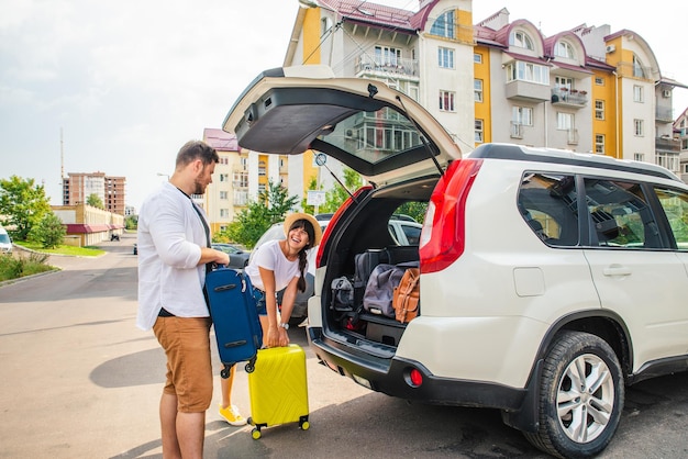 Car travel concept opened trunk with luggage inside woman with