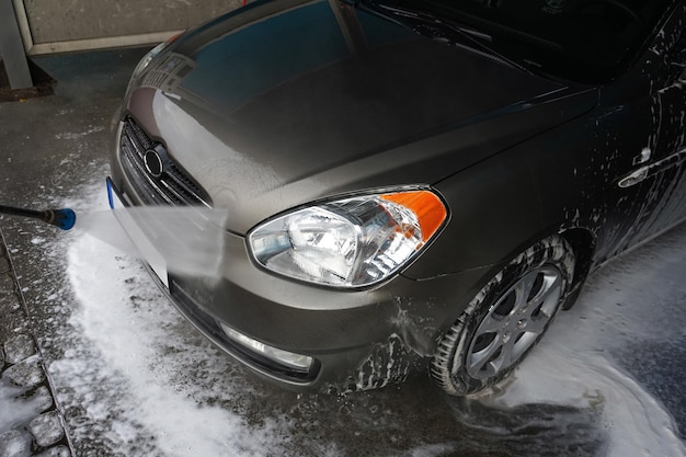 Car wash Cleaning a car with high pressure water at a car wash