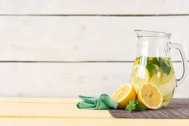 Photo carafe of lemonade and mint on a white background.