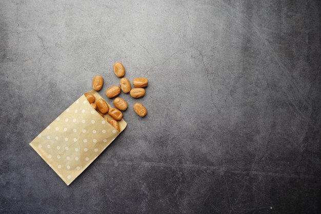 Caramel chocolate bar spilling from a paper pocket