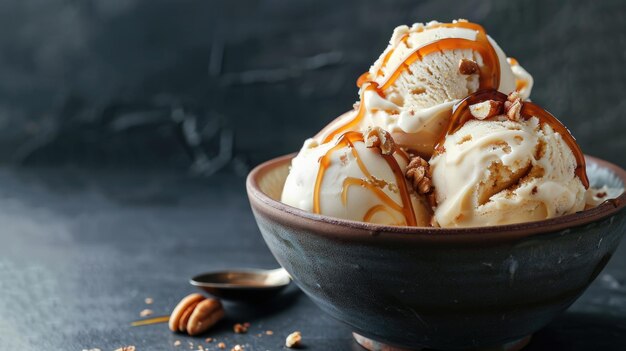 Caramel ice cream scoops in dark bowl with nuts