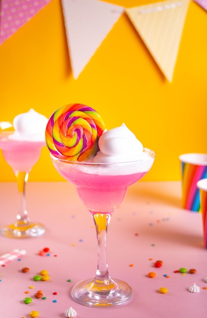 Caramel Milk shake cocktail with whipped cream and colored sweet candy lollipop