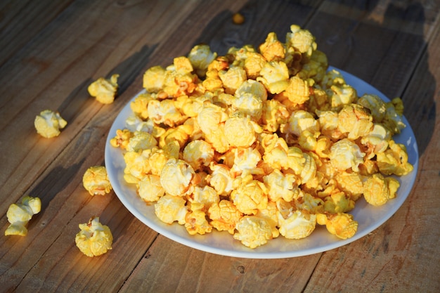 Caramel popcorn, on the wooden table