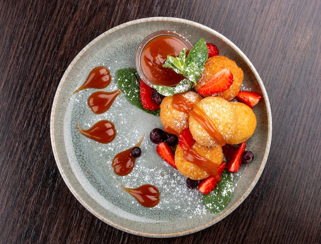 Caramel and strawberry curd balls Dessert On a wooden background