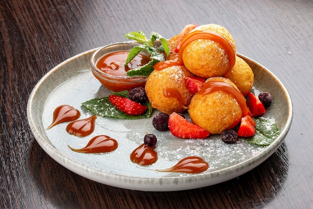 Caramel and strawberry curd balls Dessert On a wooden background