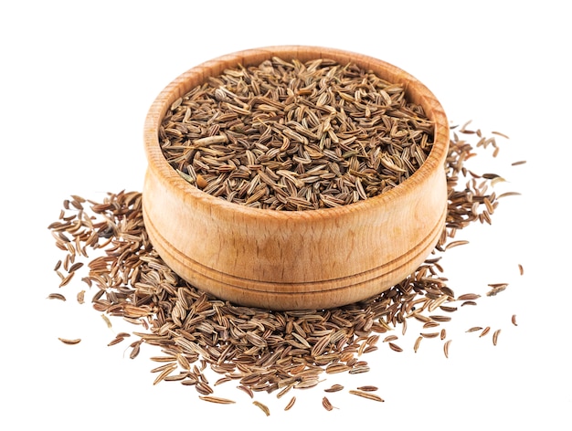 Caraway seeds in wooden bowl isolated on white background