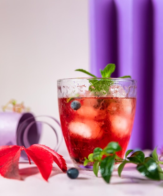 carbonated nonalcoholic pink cocktail or lemonade with sparkling grape water mint and ice