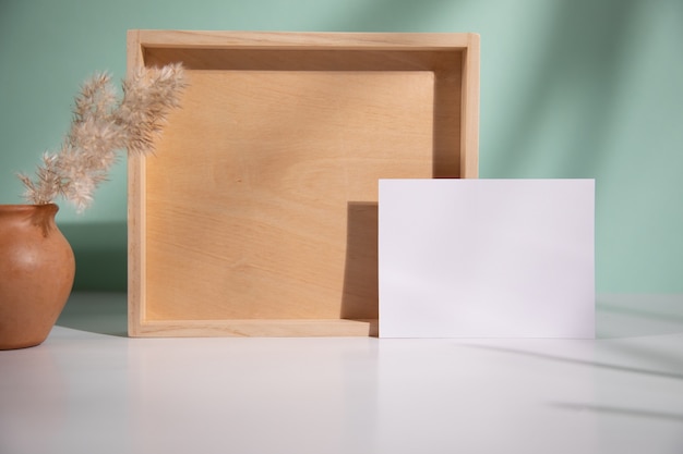 Card with wood and grass on table