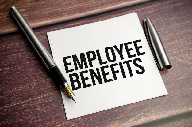 Card with words EMPLOYEE BENEFITS finance and business concept