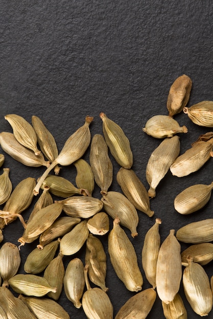 cardamom pods on black background