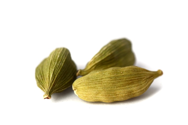 Cardamom pods on white surface