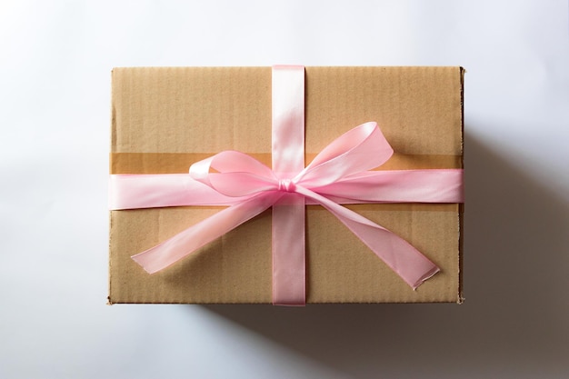 Cardboard box with a pink ribbon Gift