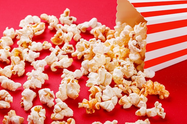 cardboard box with popcorn on a red background closeup