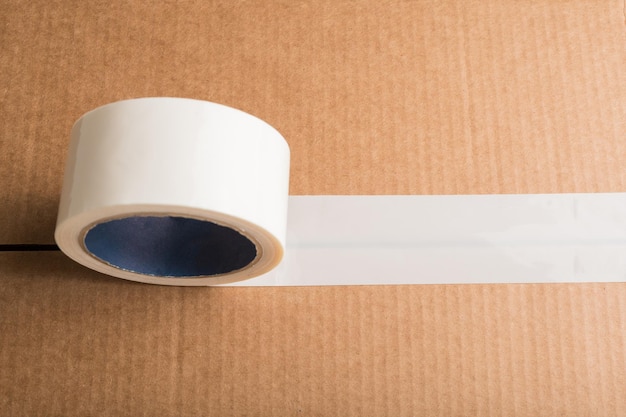 Cardboard box with white adhesive tape with copyspace