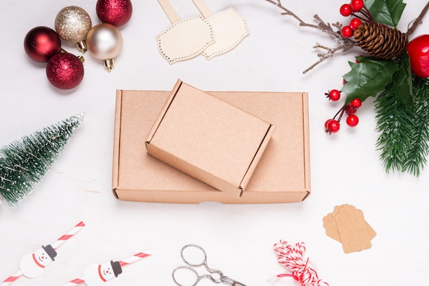 Cardboard box on wooden desk decorated with Christmas ornament