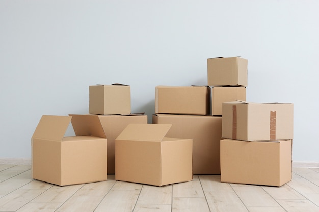 Cardboard boxes and household stuff in empty room