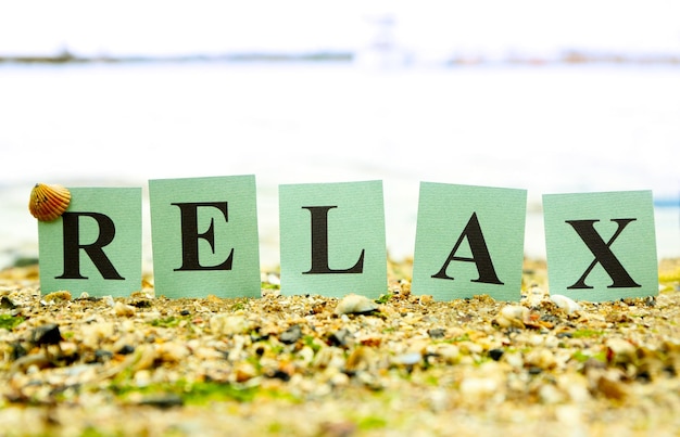 Cards with printed word RELAX on beach background