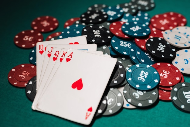 Cards with Royal flush on the chips in the game of poker