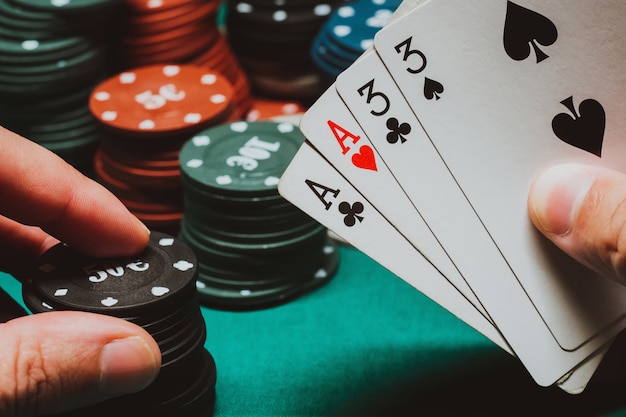 Cards with two pairs in the hands of the player in a game of poker 