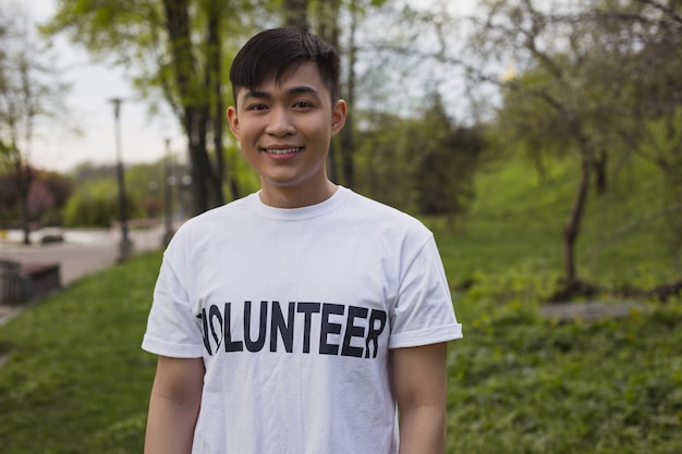 Care for nature. Attractive male volunteer posing outdoors and smiling to camera