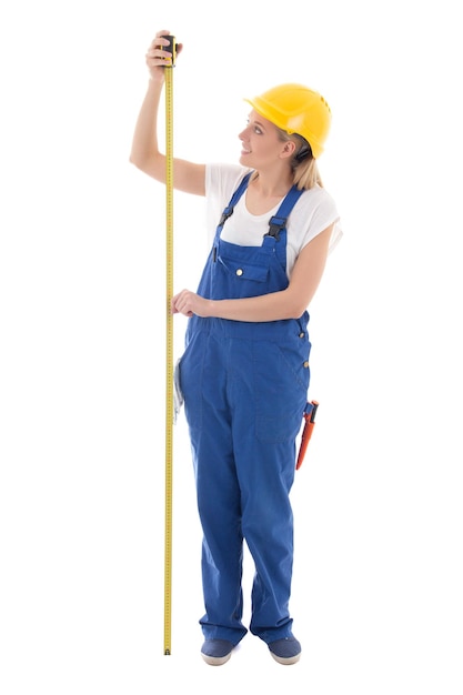 Career concept woman in blue builder uniform holding measure tape isolated on white background