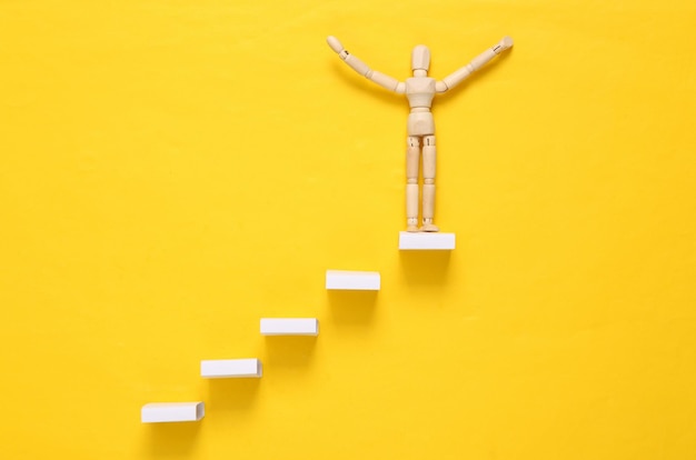 Career growth concept Wooden on stairs on a yellow background