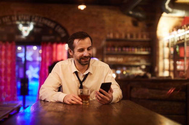 Carefree Businessman Drinking in Bar