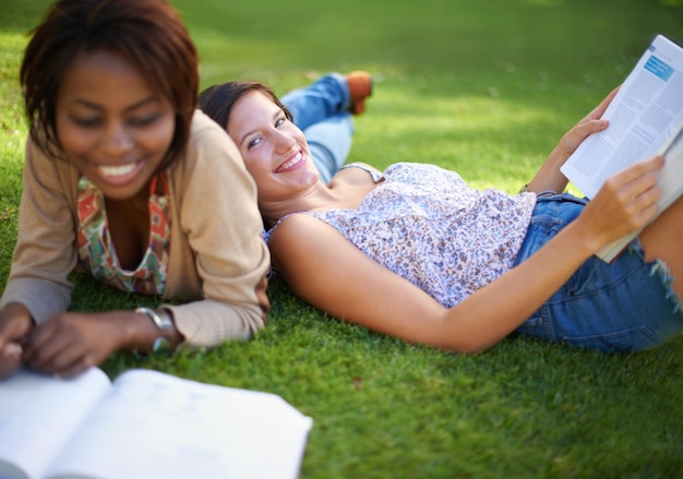 Carefree college days Cropped shot of a two beautiful young college students studying outside