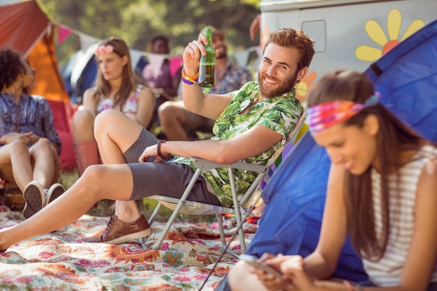 Carefree hipster relaxing on campsite