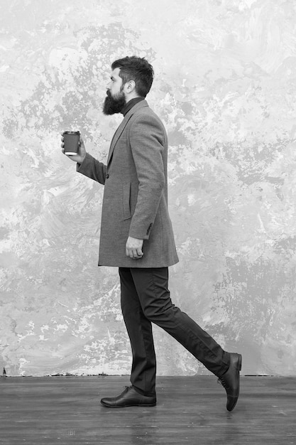 Careful with coffee cup Man handsome bearded businessman hold cup coffee Coffee break concept Business people fashion style Smart casual style clothes for office life Best coffee served for him