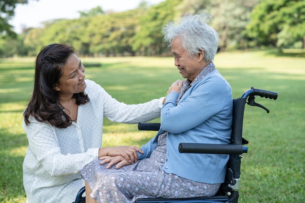 Caregiver help and care Asian elderly woman use walker with strong health