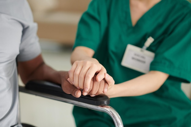 Caregiver touching hand of patient to express support